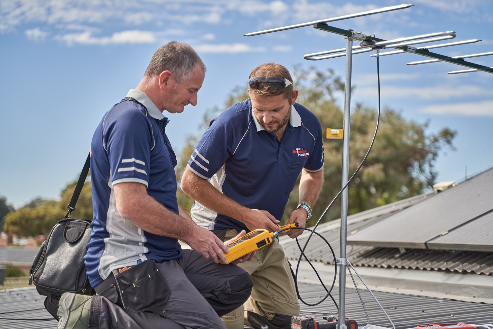 Adelaide antenna technicians installing a digital TV antenna on a rooftop